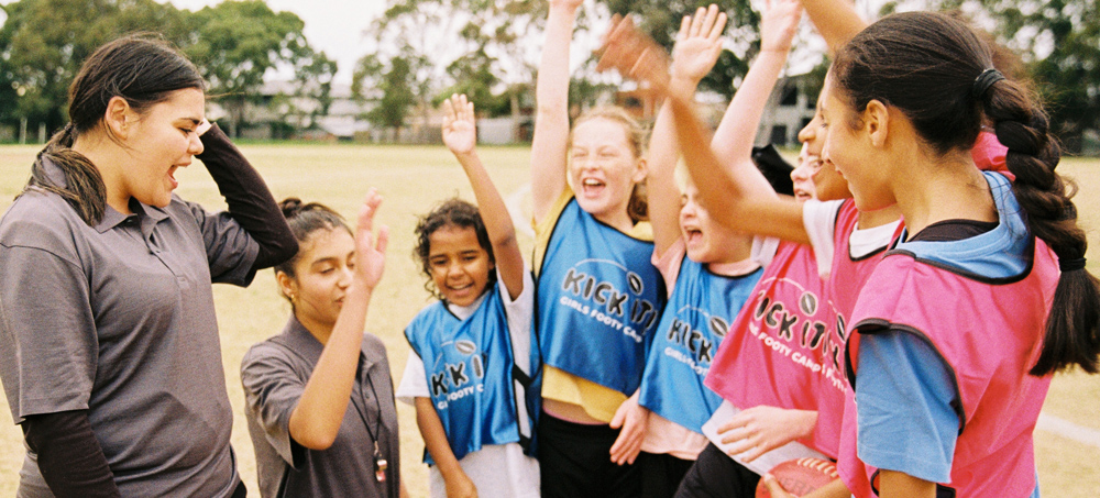 A group of netball players celebrating together